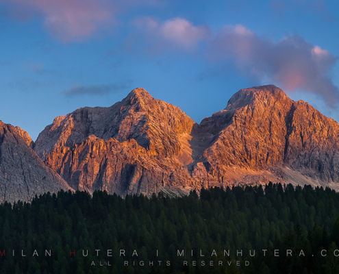 Last summer rays of Sun hit the massive cliffs near Misurina, in Dolomites, Italy.