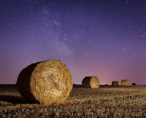 Freshly made bales under the starry summer sky. A LED flashlight was used to light paint the bales and the field.