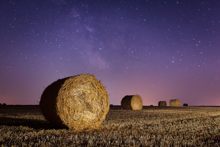 Bales and Stars Freshly made bales under the starry summer sky. A LED flashlight was used to light paint the bales and the field.