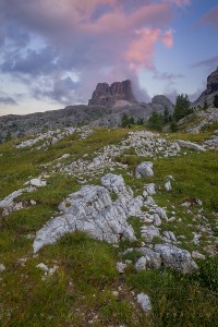 A cloud lit by setting Sun hovers above Averau mountain, located in Passo de Falzarego, Dolomites, Italy.