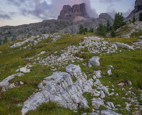 A cloud lit by setting Sun hovers above Averau mountain, located in Passo de Falzarego, Dolomites, Italy.