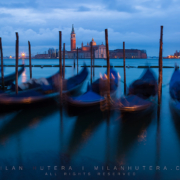 A dark and cloudy March morning in Venice. The sway of gondolas is exaggerated by long exposure. The iconic church of San Giorgio Maggiore can be seen in the backgroung.