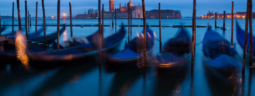 A dark and cloudy March morning in Venice. The sway of gondolas is exaggerated by long exposure. The iconic church of San Giorgio Maggiore can be seen in the backgroung.