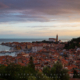 Subtle clouds with purple and yellow hues above the port city of Piran, Slovenia.