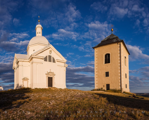 The chapel of Saint Sebastian and its belltower bathe in a warm Summer evening light. The Chapel was built in 1630 after an outbreak of plague. The adjacent belltower was built in 1632. The present bell is used for celebrational purposes.