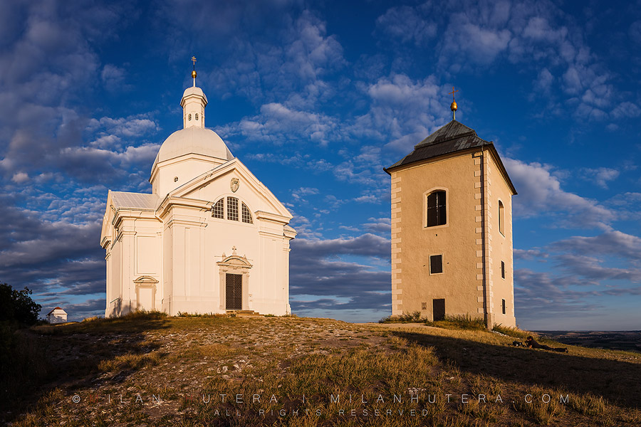 The chapel of Saint Sebastian and its belltower bathe in a warm Summer evening light. The Chapel was built in 1630 after an outbreak of plague. The adjacent belltower was built in 1632. The present bell is used for celebrational purposes.