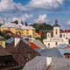 The old mining town of Banska Stiavnica is one of the most important landmarks of Slovakia and it is a part of UNESCO World Heritage Site since 1993. The mines around town were rich in silver ore and other precious metals. The town was also a home to first mining college in Europe and the first ever Technical School in the world - established in 1763. This photo depicts a late August afternoon overlooking the rooftops of the historic center of Banska Stiavnica. The metal and wooden rooftops are a necessity due to large snowfall in winter months. The hilltop Calvary, which is perhaps the town's most famous landmark, is visible in the distance.