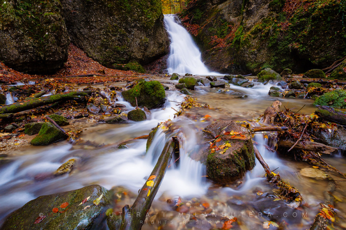 Autumn at Kraliky waterfall A colorful autumn at Kraliky waterfall in Central Slovakia. This small gorge is located just outside Banska Bystrica with the 7 meter tall waterfall at its end. The amount of water running throught the waterfall was impressive on this overcast autumn day.