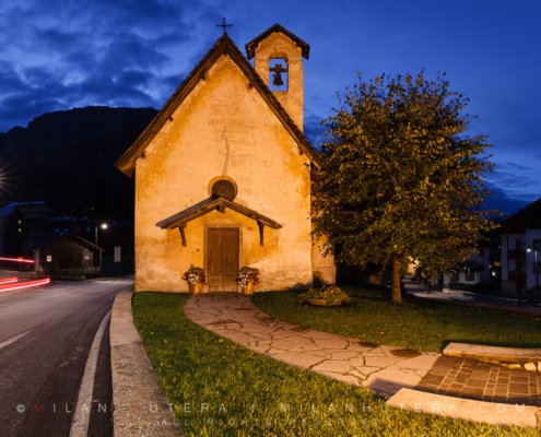 Blue hour at tiny Chiesa di San Francesco (Church of Saint Francis) in Cortina d'Ampezzo, Dolomites, Italy. It dates back to 1396 when it's mentioned for the first time in a contract of sale. It's located right next to main street loop running through the Cortina.