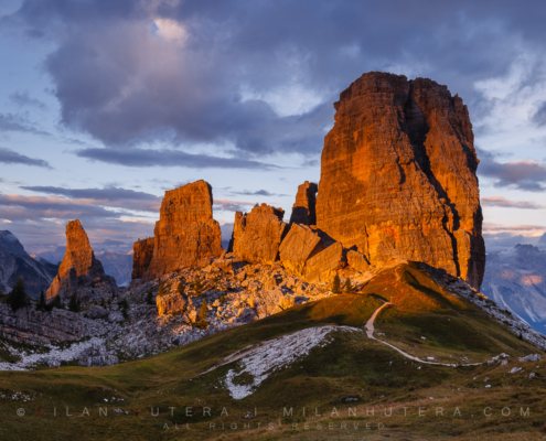 A brief warm sunrays hit the famous towers of Cinque Torri mountain on a cloudy september evening. The beautiful sunset light lasted for only about a minute, then the opening in the clouds closed and never reappeared that day.