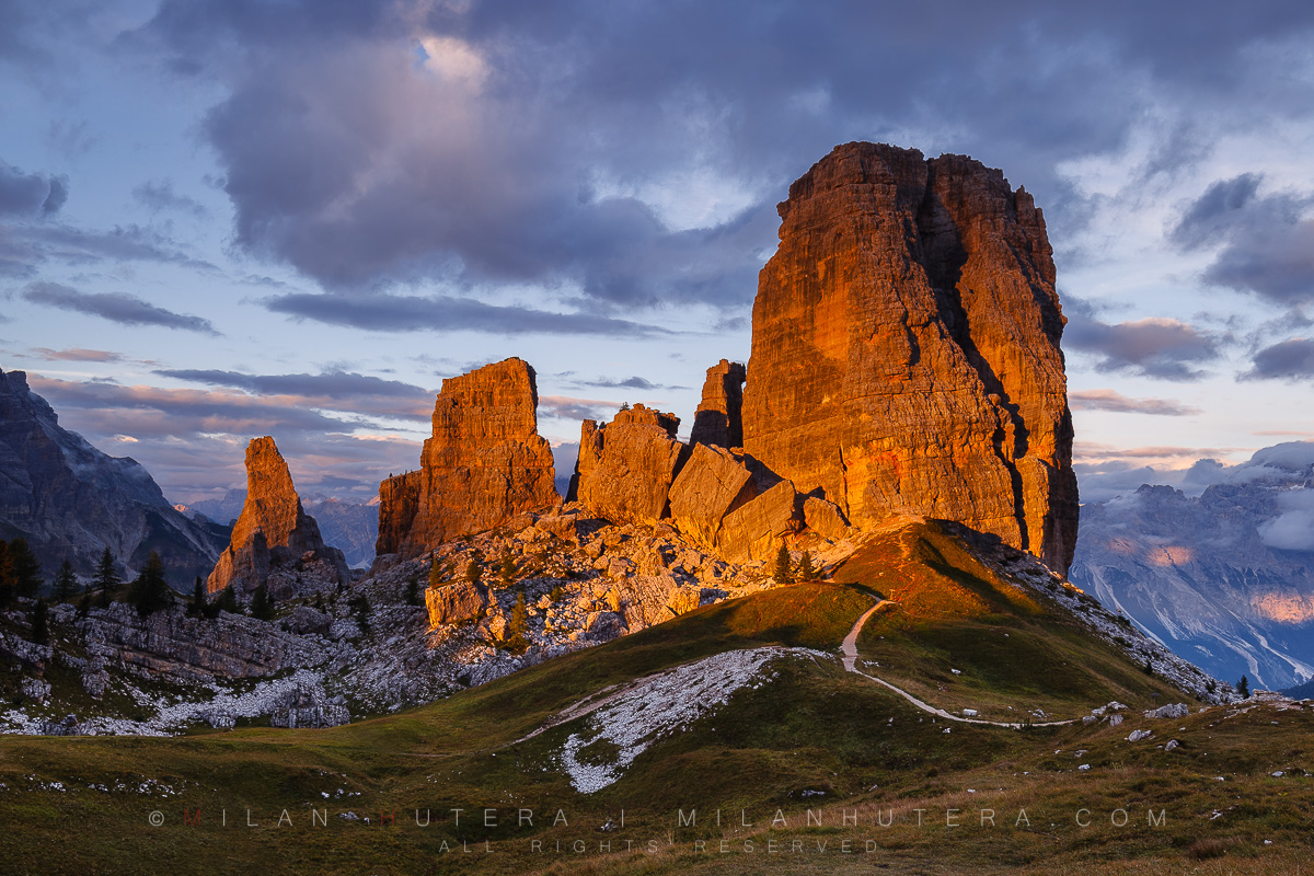 A brief warm sunrays hit the famous towers of Cinque Torri mountain on a cloudy september evening. The beautiful sunset light lasted for only about a minute, then the opening in the clouds closed and never reappeared that day.