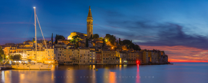 Panoramic photograph of Rovinj Croatia showing the transition from twilight sky to night city lights