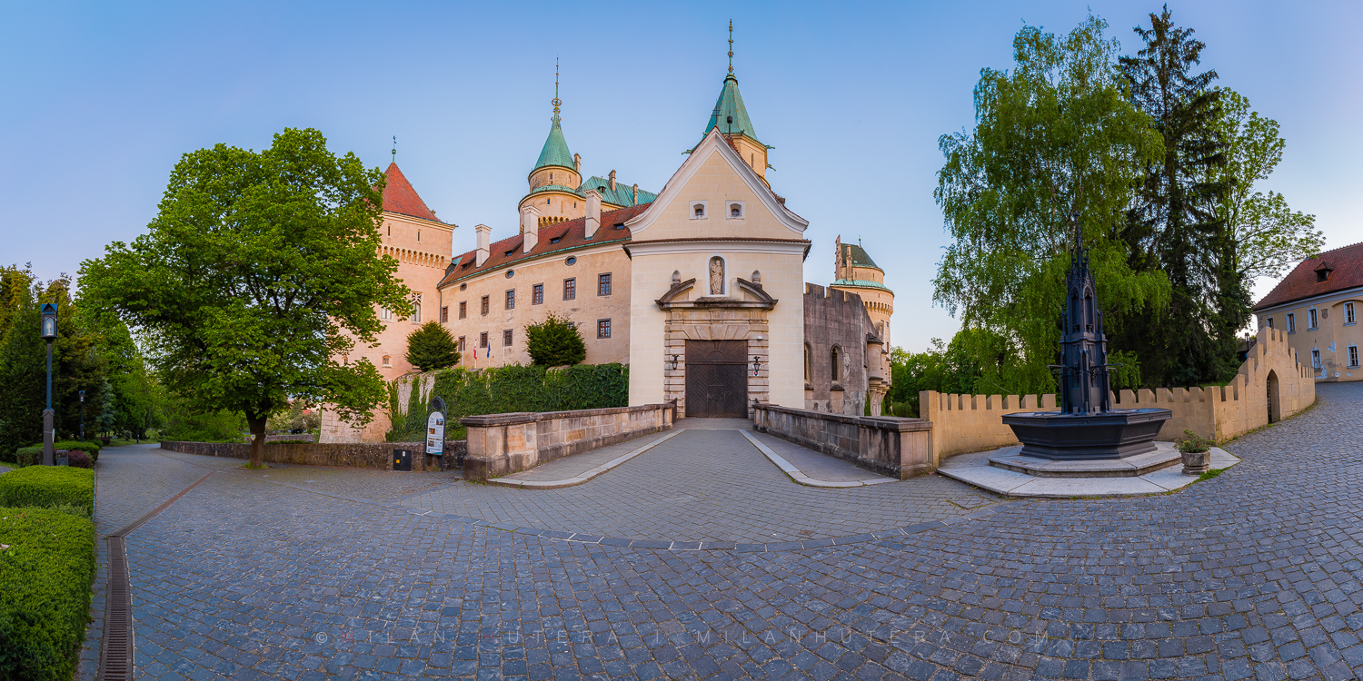 Bojnice Castle in Soft Light A wide-angle perspective of the castle entrance, bathed in the soft glow of the evening Sun."