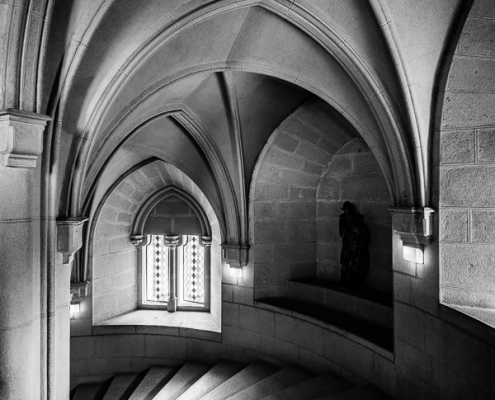Black and white photography of 137 stone steps and Neo-Gothic arches in the Middle Castle of Bojnice.