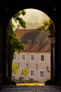 A beautiful morning shot through a Cesky Krumlov Castle gateway in golden light