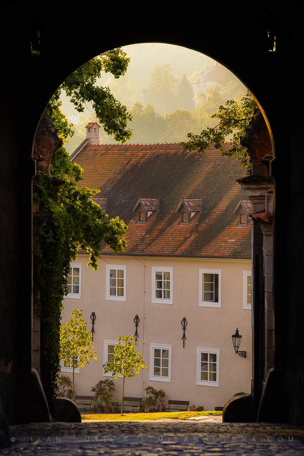A beautiful morning shot through a Cesky Krumlov Castle gateway in golden light
