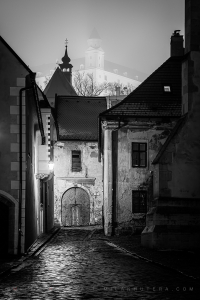 Black and white photography of Farská Street in Bratislava, with the Castle in the fog.