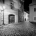 Black and white night photograph from the series Ve Stinadlech showing an old dark Prague alley as featured in Rychlé Šípy novels and comics by Jaroslav Foglar