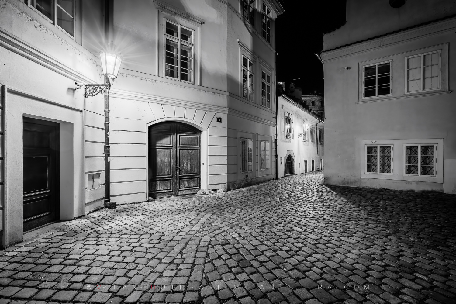 Ve Stínadlech 1, Prague, Czech Republic Black and white night photograph from the series Ve Stinadlech showing an old dark Prague alley as featured in Rychlé Šípy novels and comics by Jaroslav Foglar