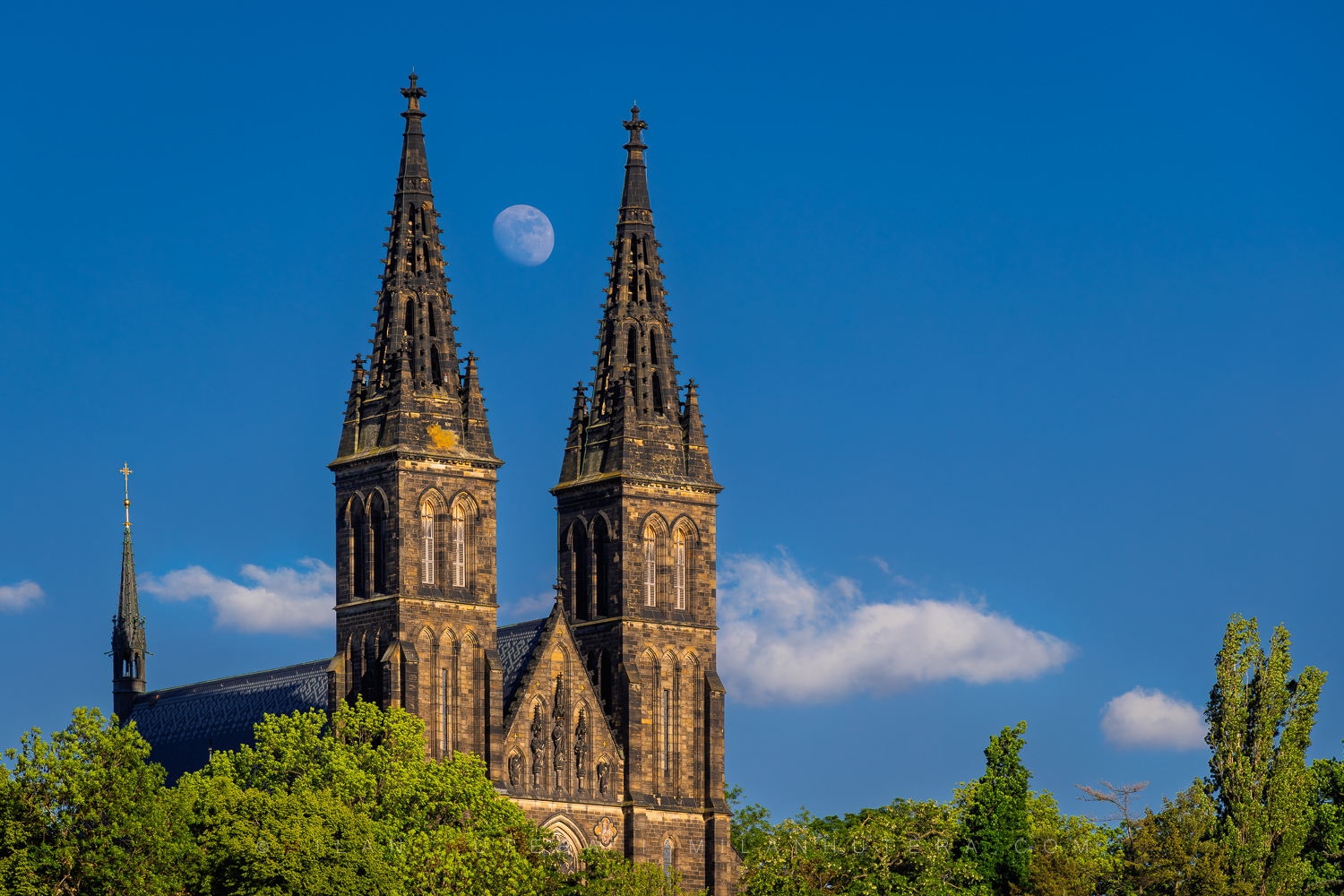 Vyšehrad Moonrise showing a daytime moon between the twin towers of the basilica in Prague.