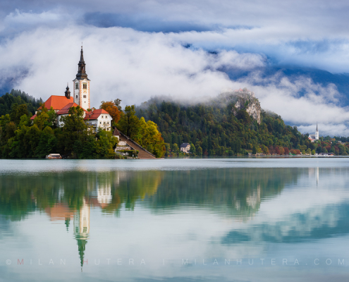 Panoramic view of Bled Lake in Slovenia on a foggy morning with the island church, Bled Castle and the town of Bled reflected in the Bled Lake