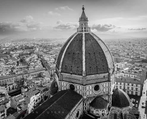 Black and white photograph of Florence Cathedral looking down from Giotto's Campanile in Florence, Italy, showcasing Brunelleschi's magnificent dome.