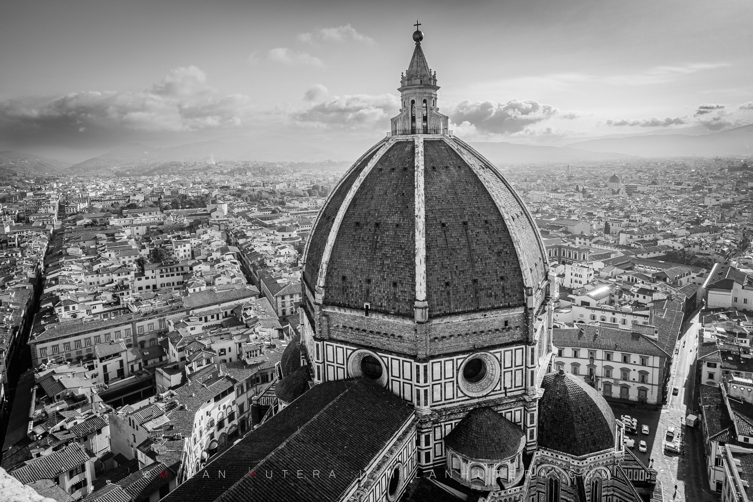 Black and white photograph of Florence Cathedral looking down from Giotto's Campanile in Florence, Italy, showcasing Brunelleschi's magnificent dome.
