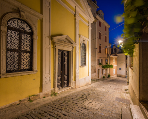 Piran alleyways twilight view of the historic Church of Our Lady of Consolation on IX. korpusa street.