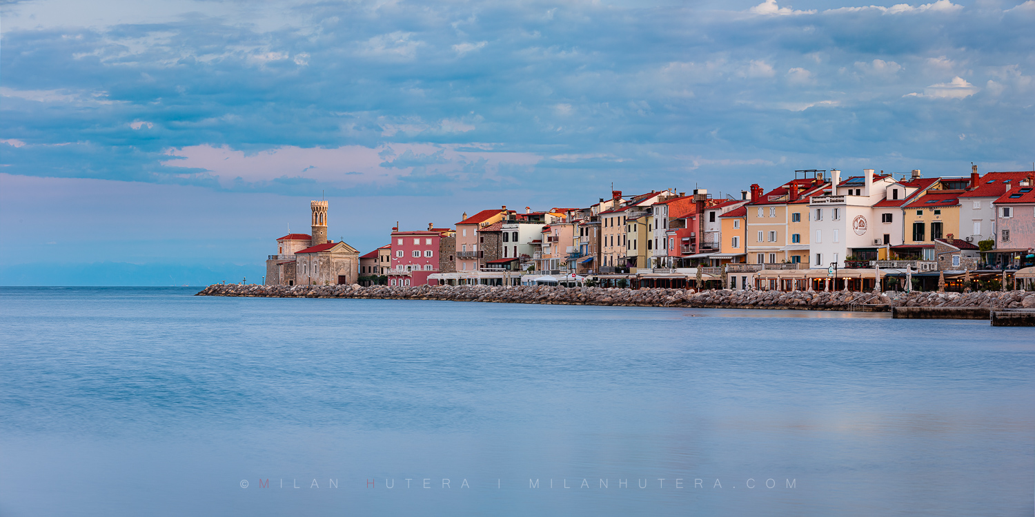 Piran coastline at dawn featuring the historic Church of Mary of Health on the peninsula's tip