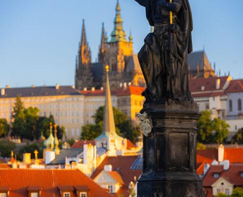 The Saint's Touch, Prague, Czech Republic — St John the Baptist statue on Charles Bridge "touches" the distant spire of St Vitus Cathedral in the morning light