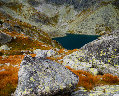Veľké Hincovo pleso lake hidden behind rocks in early autumn, High Tatras, Slovakia