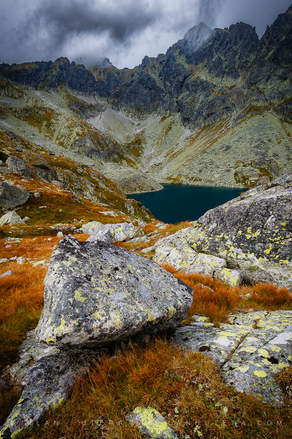 Veľké Hincovo pleso lake hidden behind rocks in early autumn, High Tatras, Slovakia
