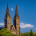 Vyšehrad Moonrise showing a daytime moon between the twin towers of the basilica in Prague.