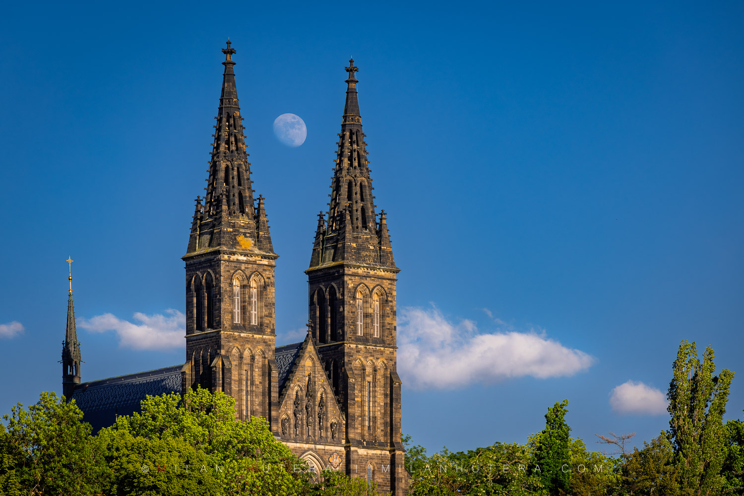 Vyšehrad Moonrise, Prague, Czech Republic Vyšehrad Moonrise showing a daytime moon between the twin towers of the basilica in Prague.