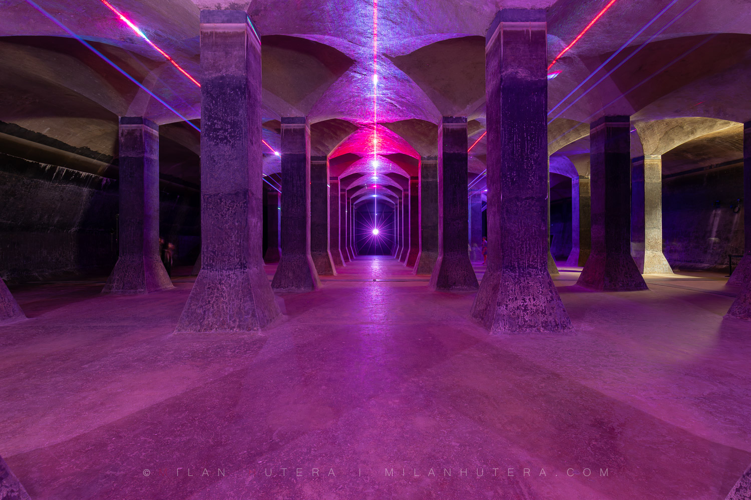 1917 Žlutý Kopec Water Reservoir, Brno, Czech Republic Cyberpunk-style laser light art installation reflecting on the concrete pillars and architecture inside the 1917 Žlutý kopec water reservoir.