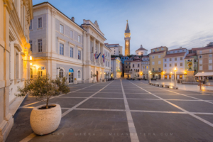 Tartini Square morning photo in Piran, Slovenia, showing the empty square, the Town Hall, and St. George's Parish Church bell tower