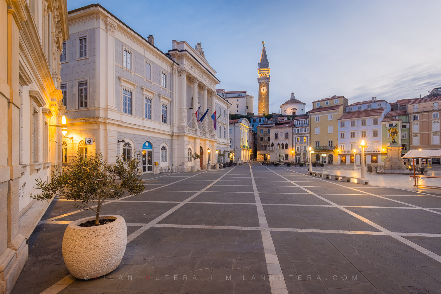 Tartini Square morning photo in Piran, Slovenia, showing the empty square, the Town Hall, and St. George's Parish Church bell tower