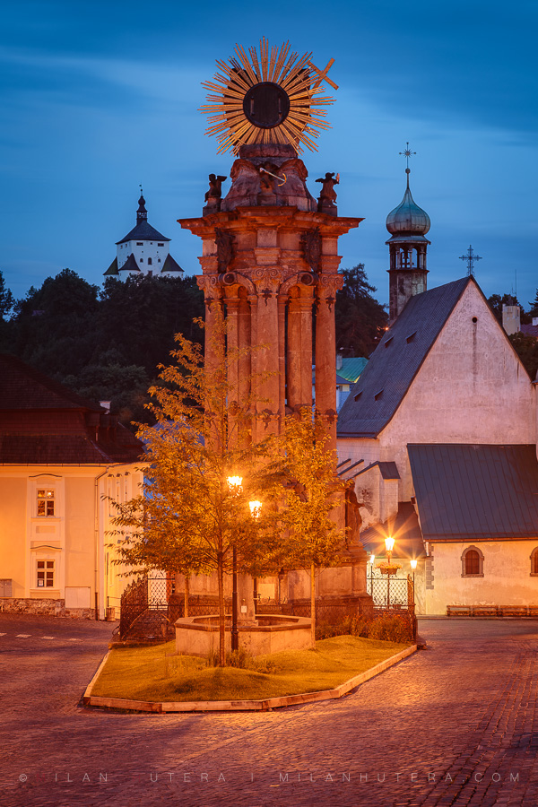 Holy Trinity Square in Banská Štiavnica during blue hour with illuminated Baroque plague column
