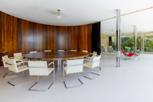 Villa Tugendhat dining area with curved Macassar ebony wall and white Brno chairs
