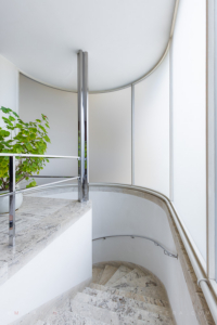 Villa Tugendhat staircase made of travertine with curved milk glass wall in Brno, Czech Republic