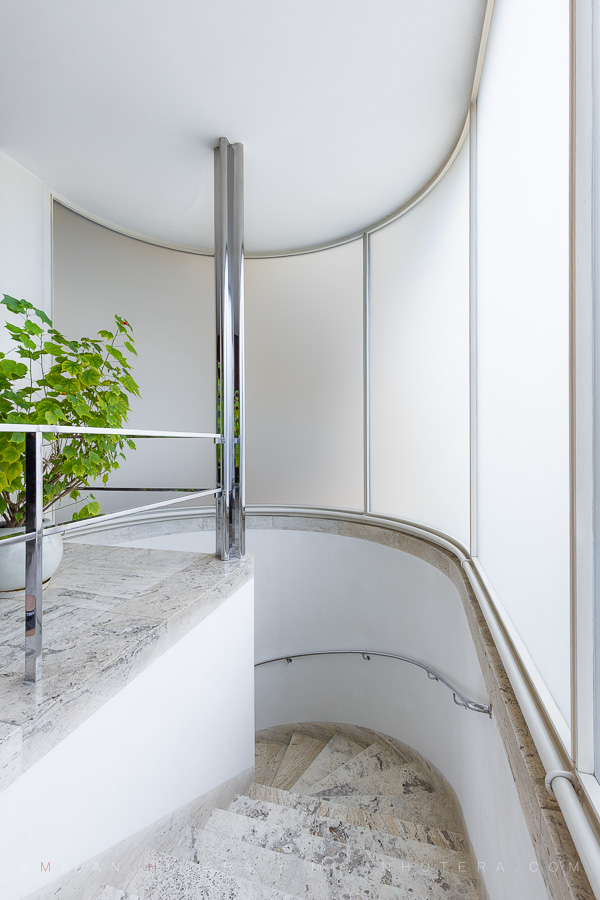 Villa Tugendhat staircase made of travertine with curved milk glass wall in Brno, Czech Republic