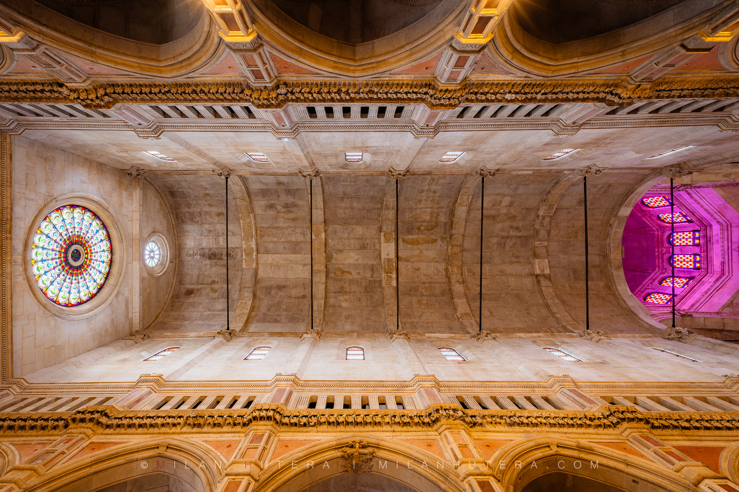 St. James Cathedral ceiling in Šibenik, Croatia with stone vaulting, stained glass and purple light inside the dome